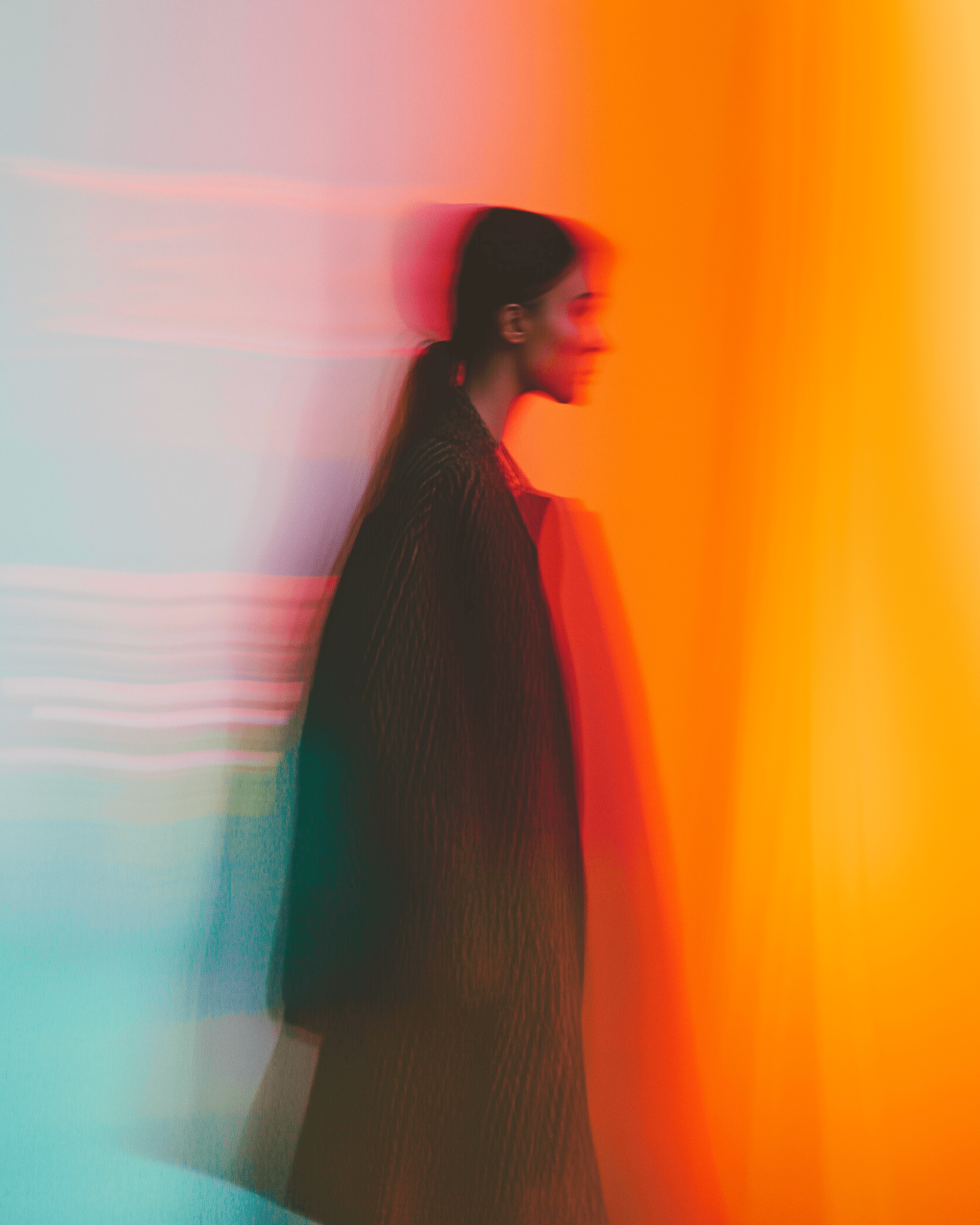 Figure in red-orange tones with motion blur, creating an abstract, energetic feel.