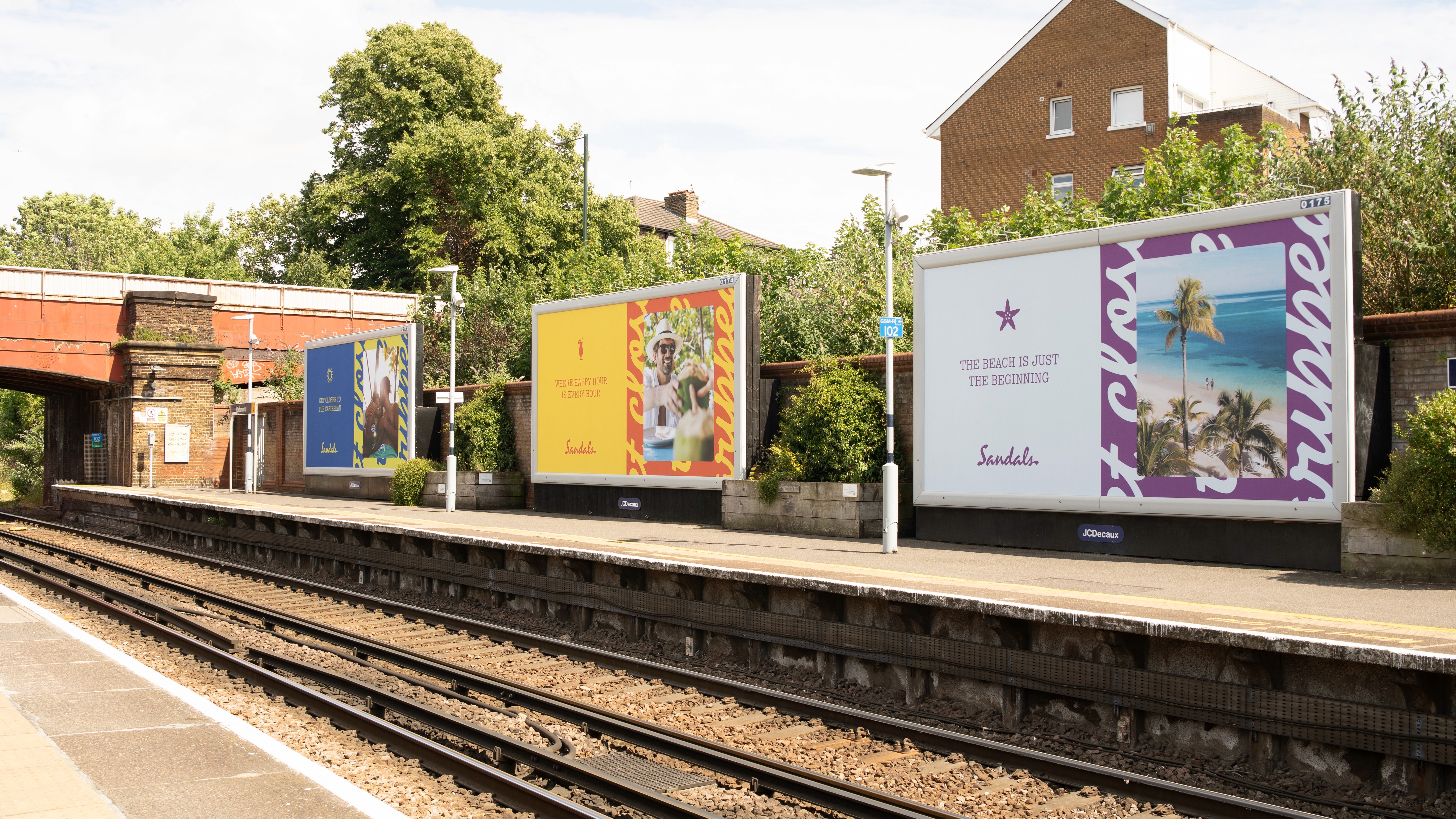 Close-up of a professional camera filming inside a modern bar or restaurant setting, with tables and bottles visible in the background.