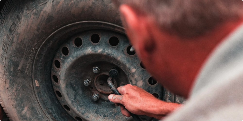 a man is changing a wheel on a car