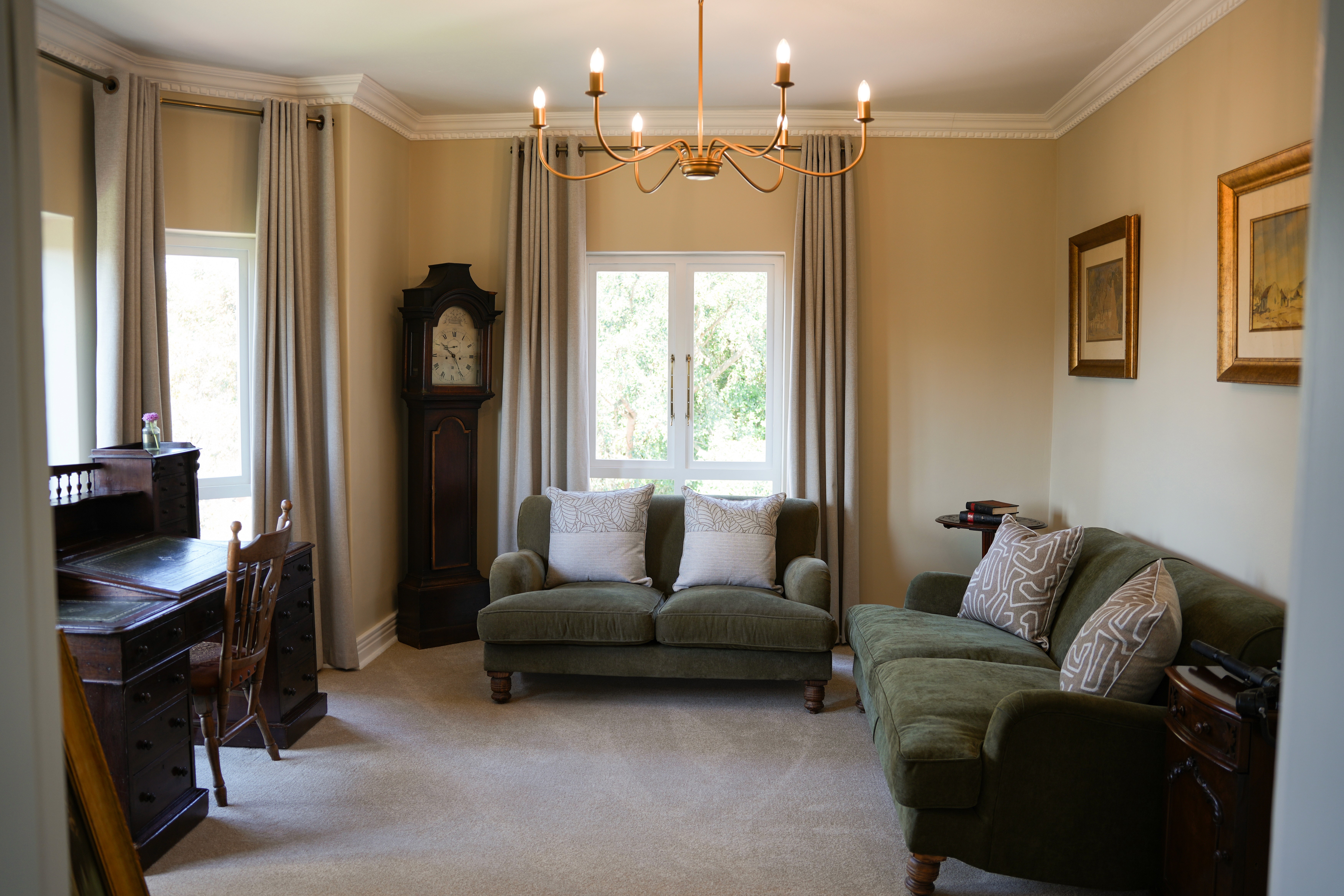 Elegant workspace in Redlands Hotel Premier Room with desk, chair, and garden view.