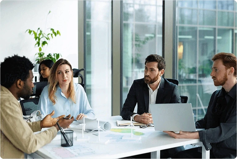 Business team discussing plans at a table in a meeting room