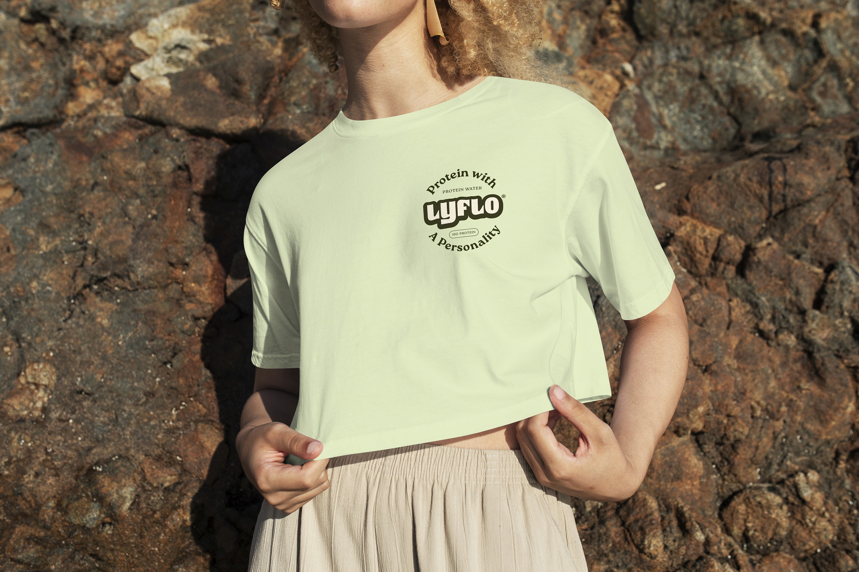 Woman wearing light green shirt with "Lyflo" branding