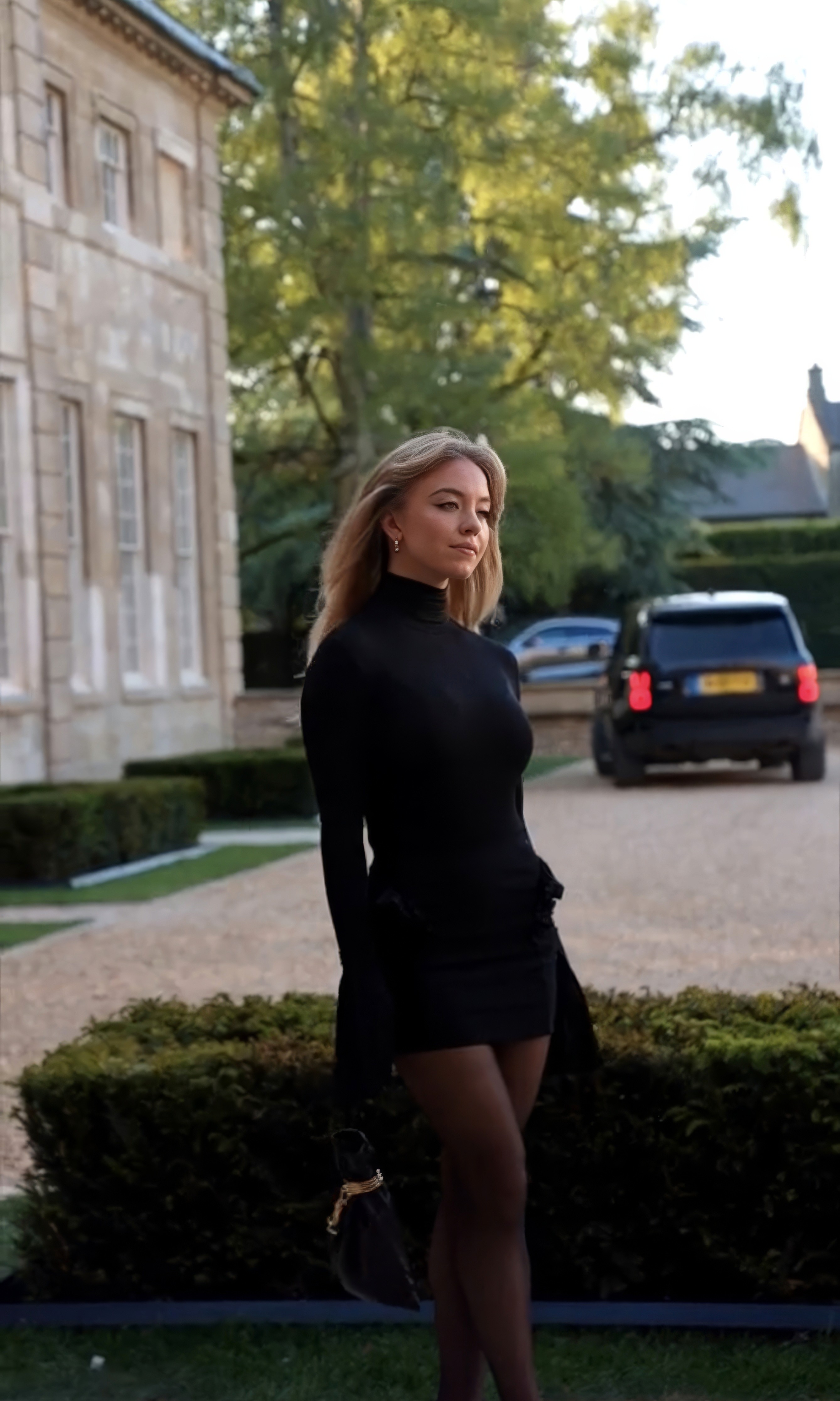 Couple embracing on street, bride's face obscured