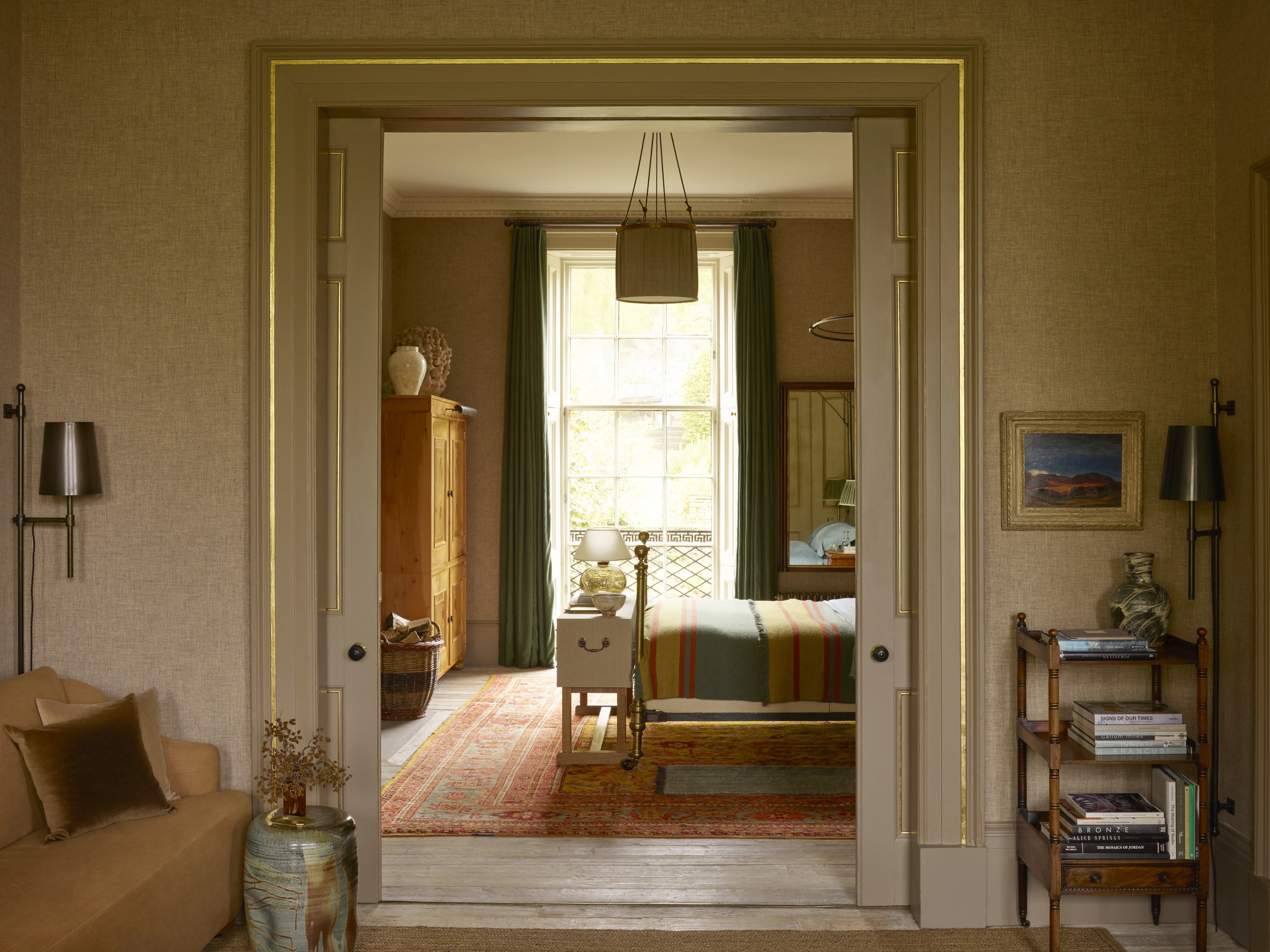 View of a bedroom entryway with an open door, showing a glimpse of the interior including the bed and surrounding decor.