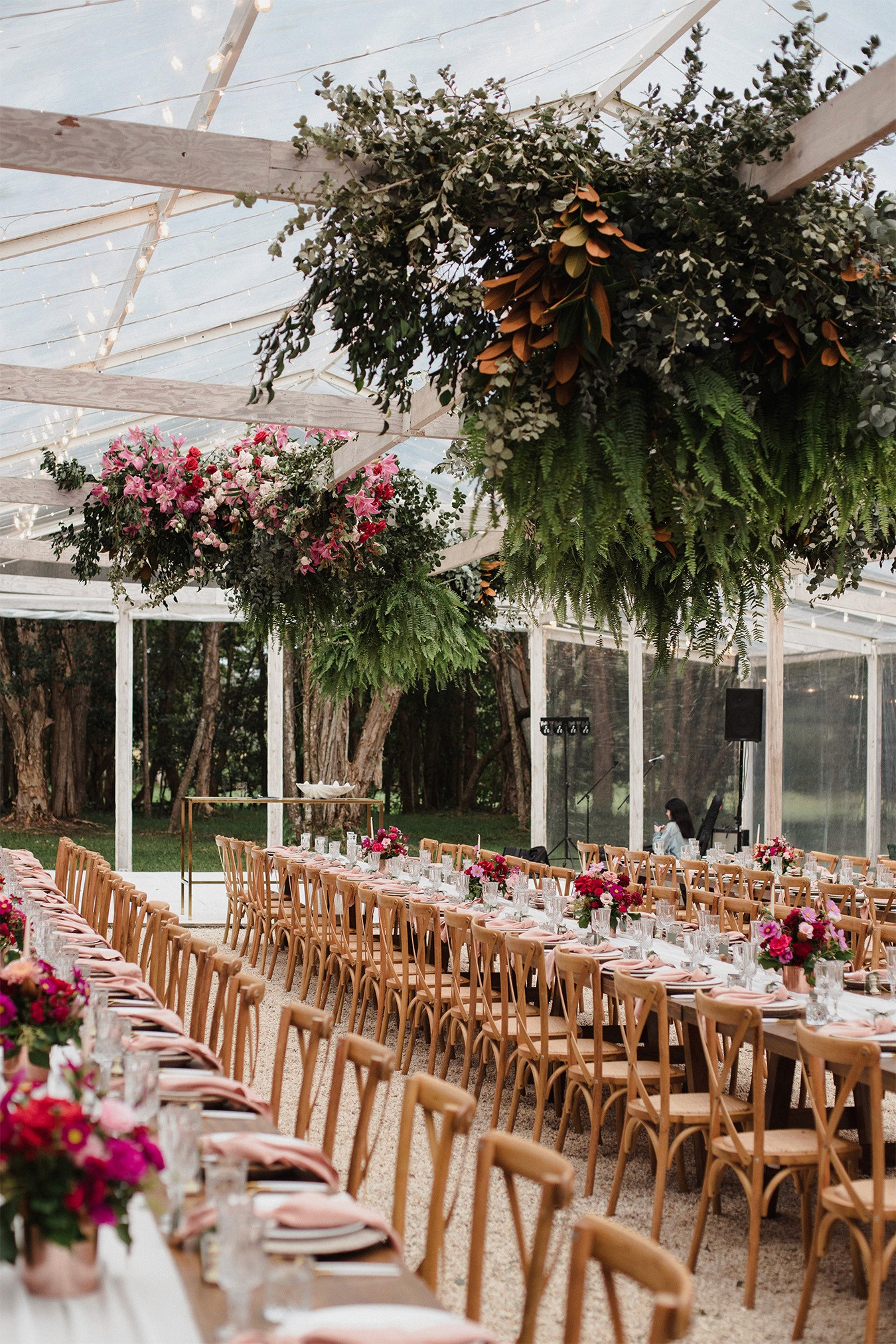 Wedding reception table settings in an outdoor marquee
