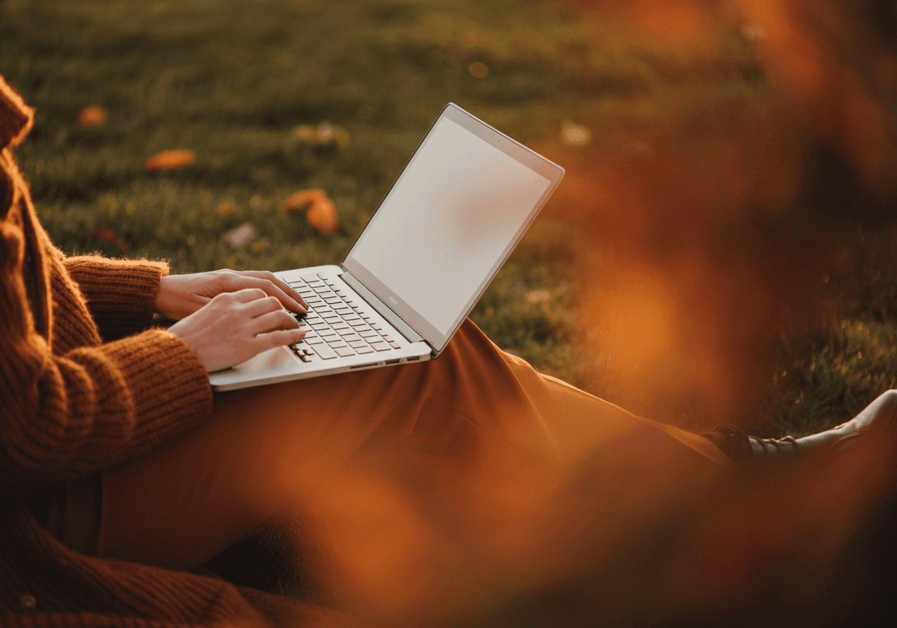 Somebody using their laptop in an outdoor space