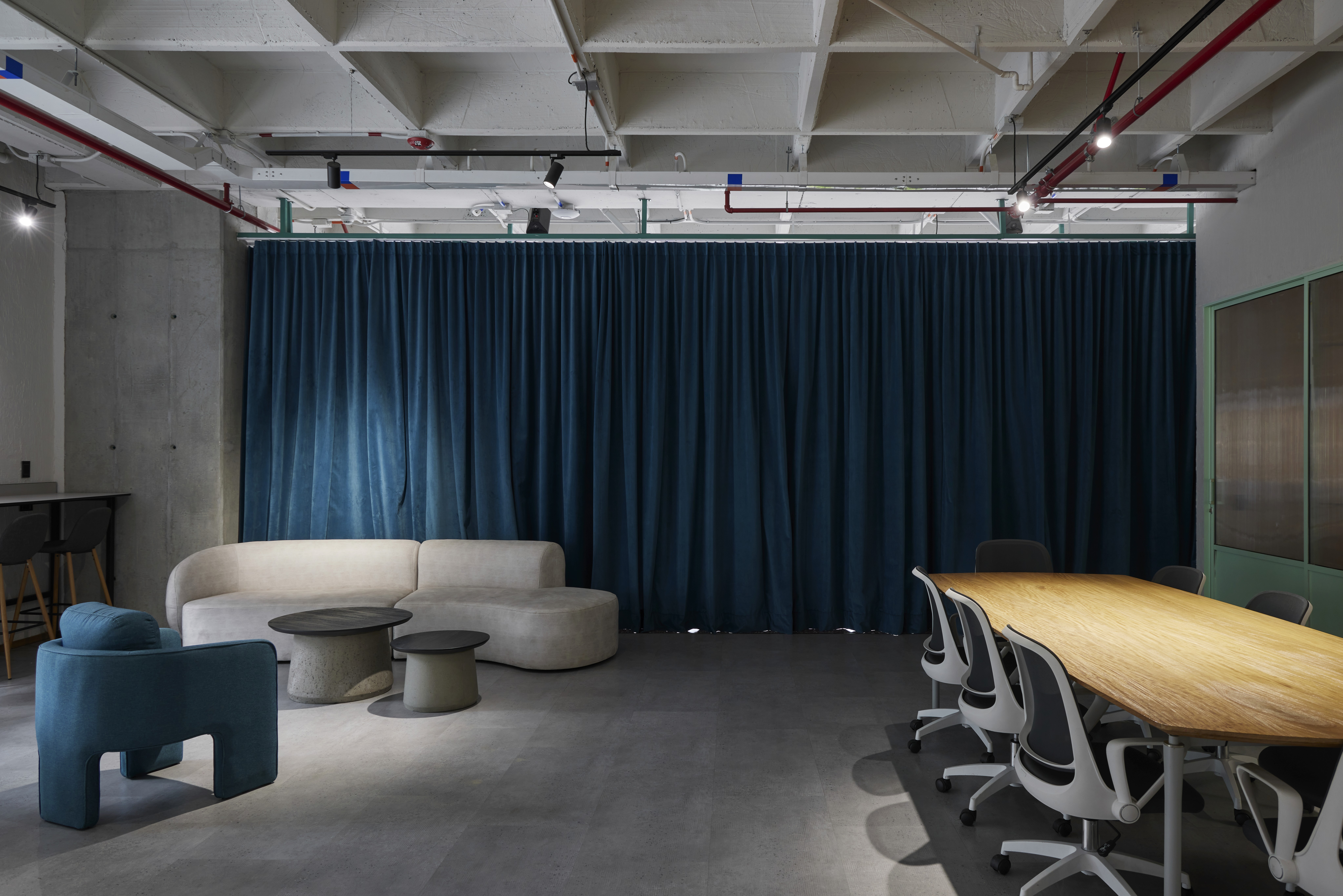 Double-height interior with flowing sculptural forms and warm raking light