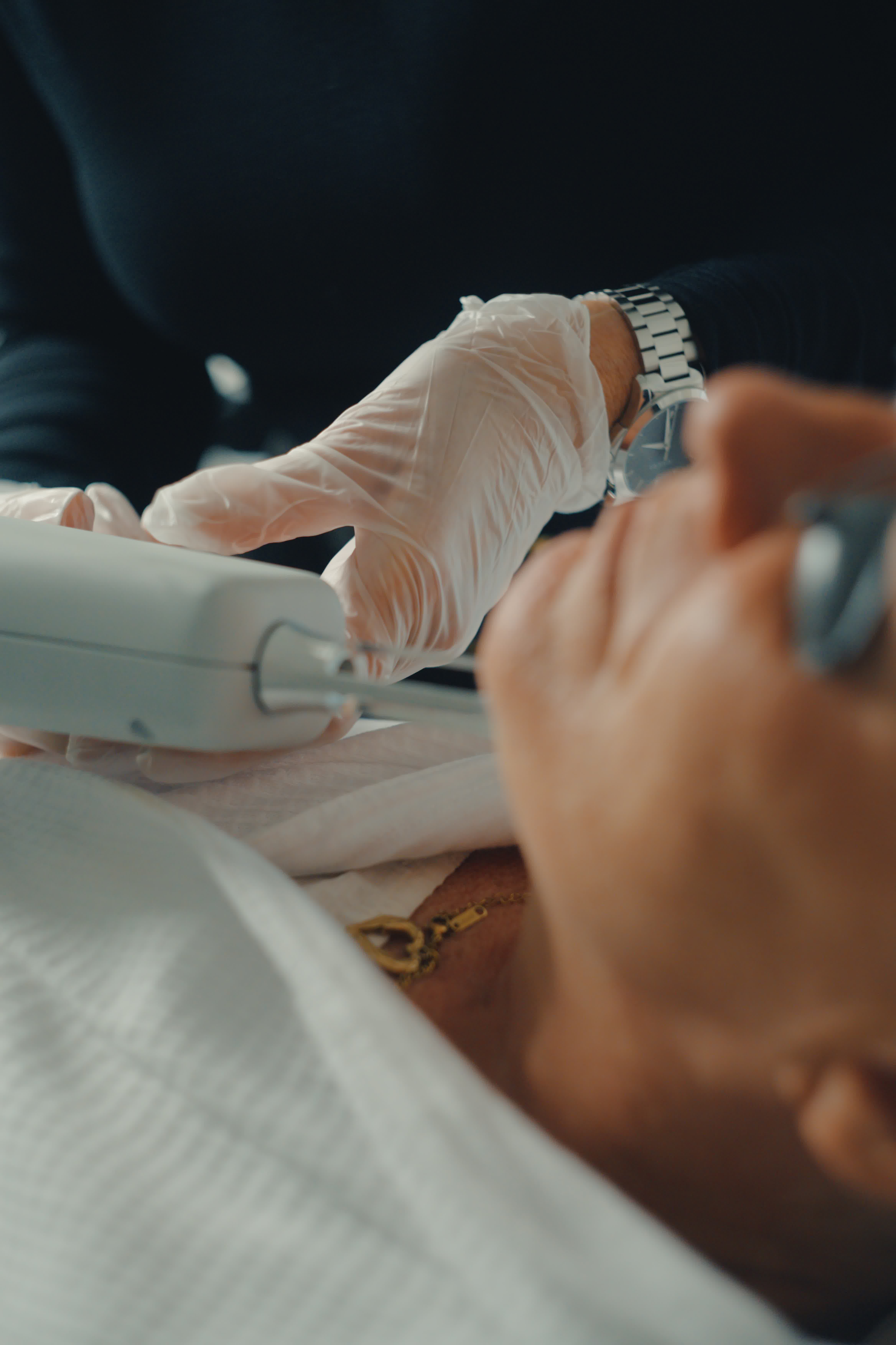 Laser treatment on woman's cheek with protective eye shield
