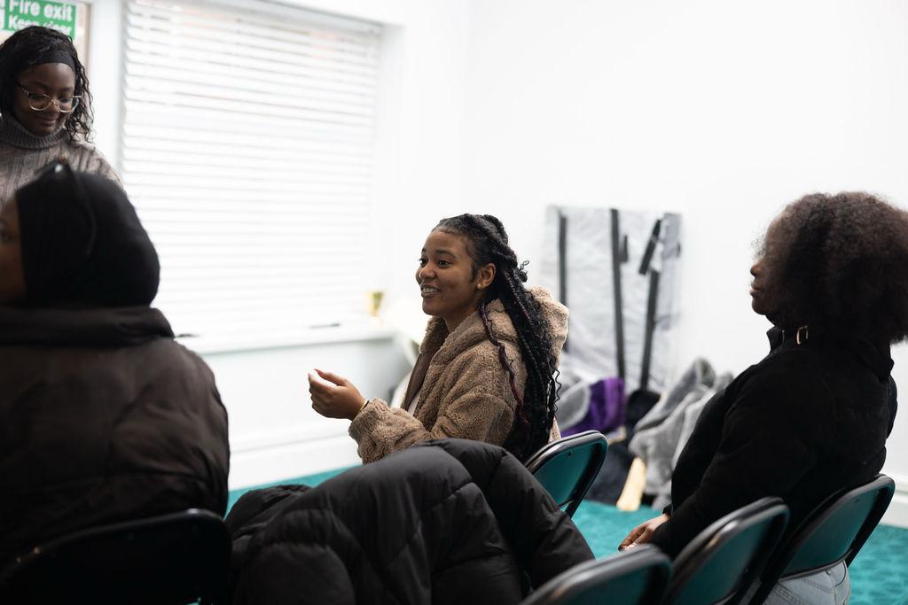 a group of children sitting on steps in front of a building