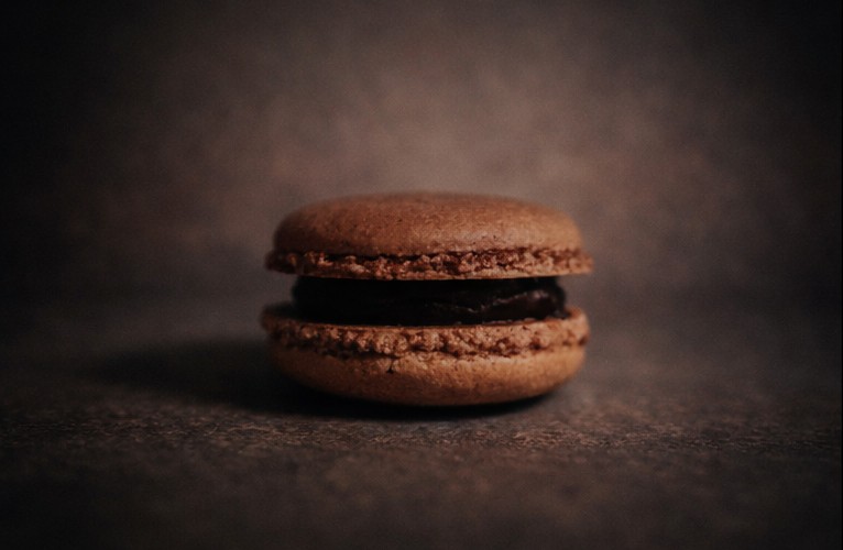 Chocolate Salted Caramel Macaron with silky ganache and salted caramel filling at Café Sherpa's in Brookfield, WI. Rich chocolate shells finished with a touch of sea salt.