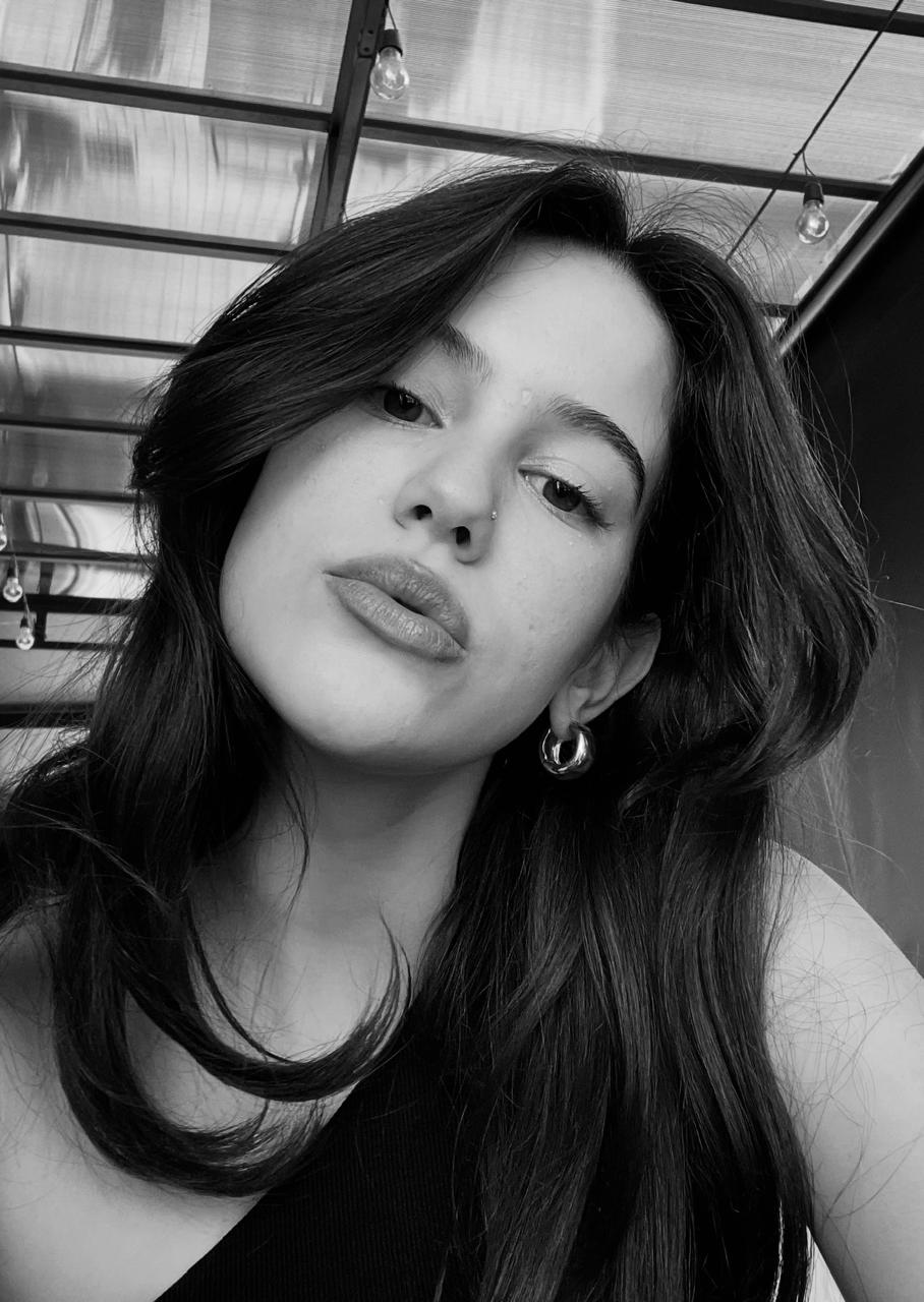 a blurry photo of a person standing in front of a wall