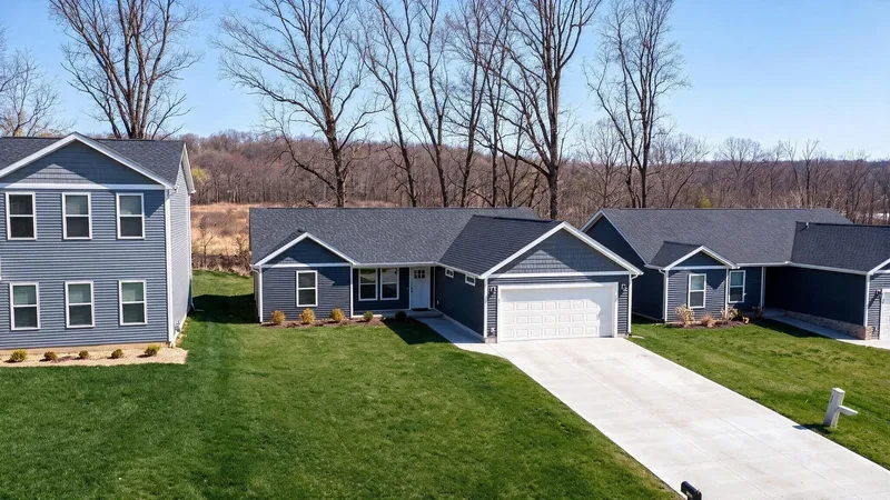 Brushwood Single-Family: navy-sided single-family homes with white wireframe lines traced over the rooflines, on new lawns with concrete driveways