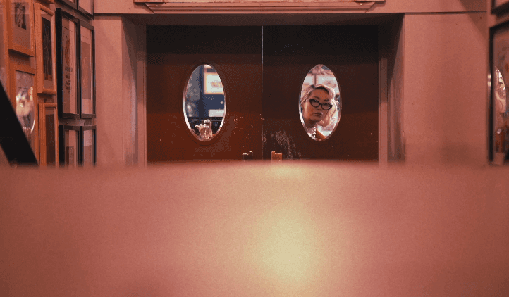 Woman hugging Shiba Inu dog, both looking at camera