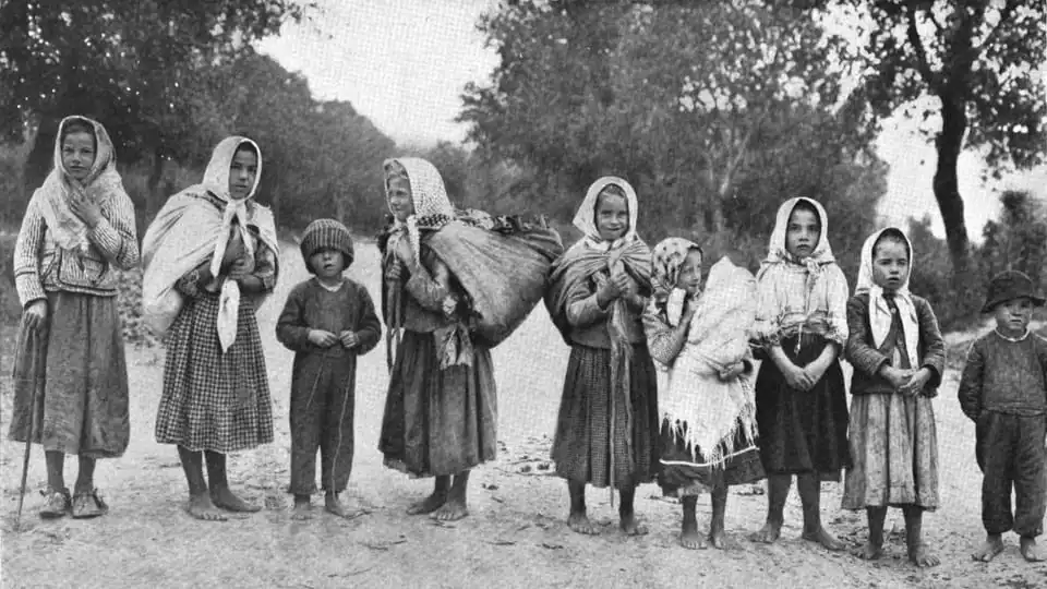 Children standing on a rural road in an old photograph