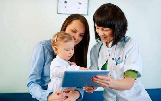 Лікар показує дитині планшет