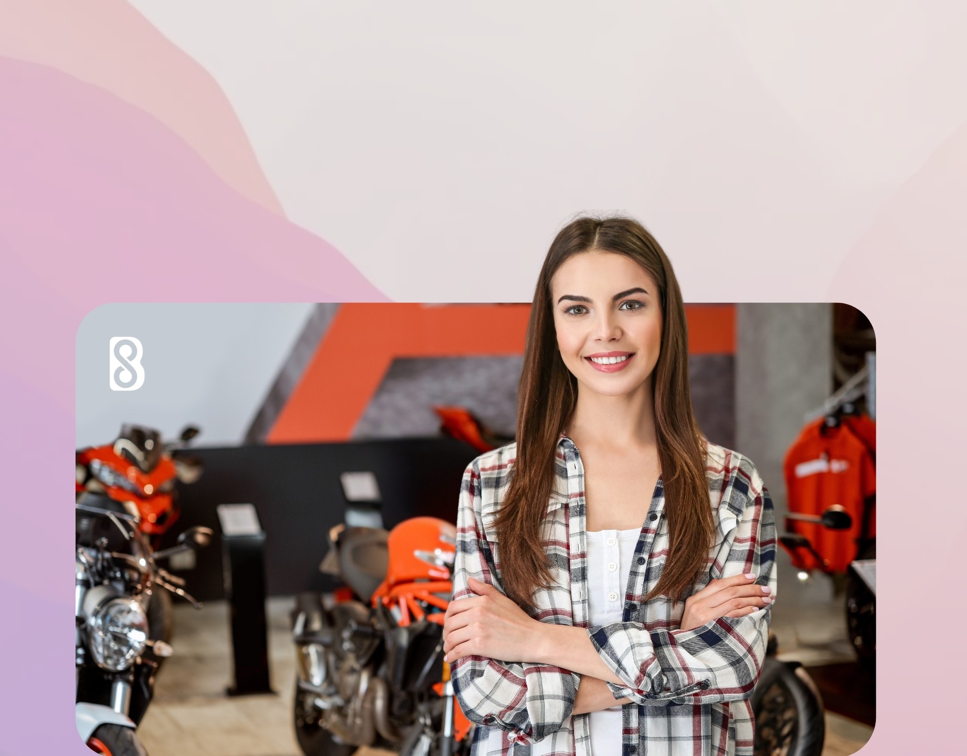 A female executive standing infront of her bikes in a motorbike dealership 