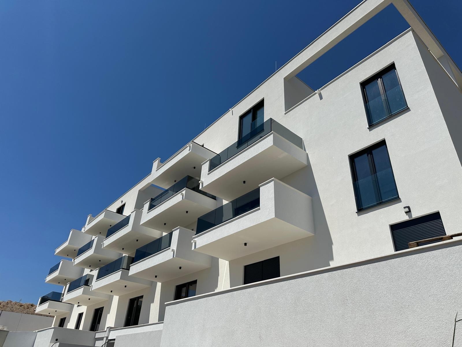 Apartment building exterior with multiple windows.