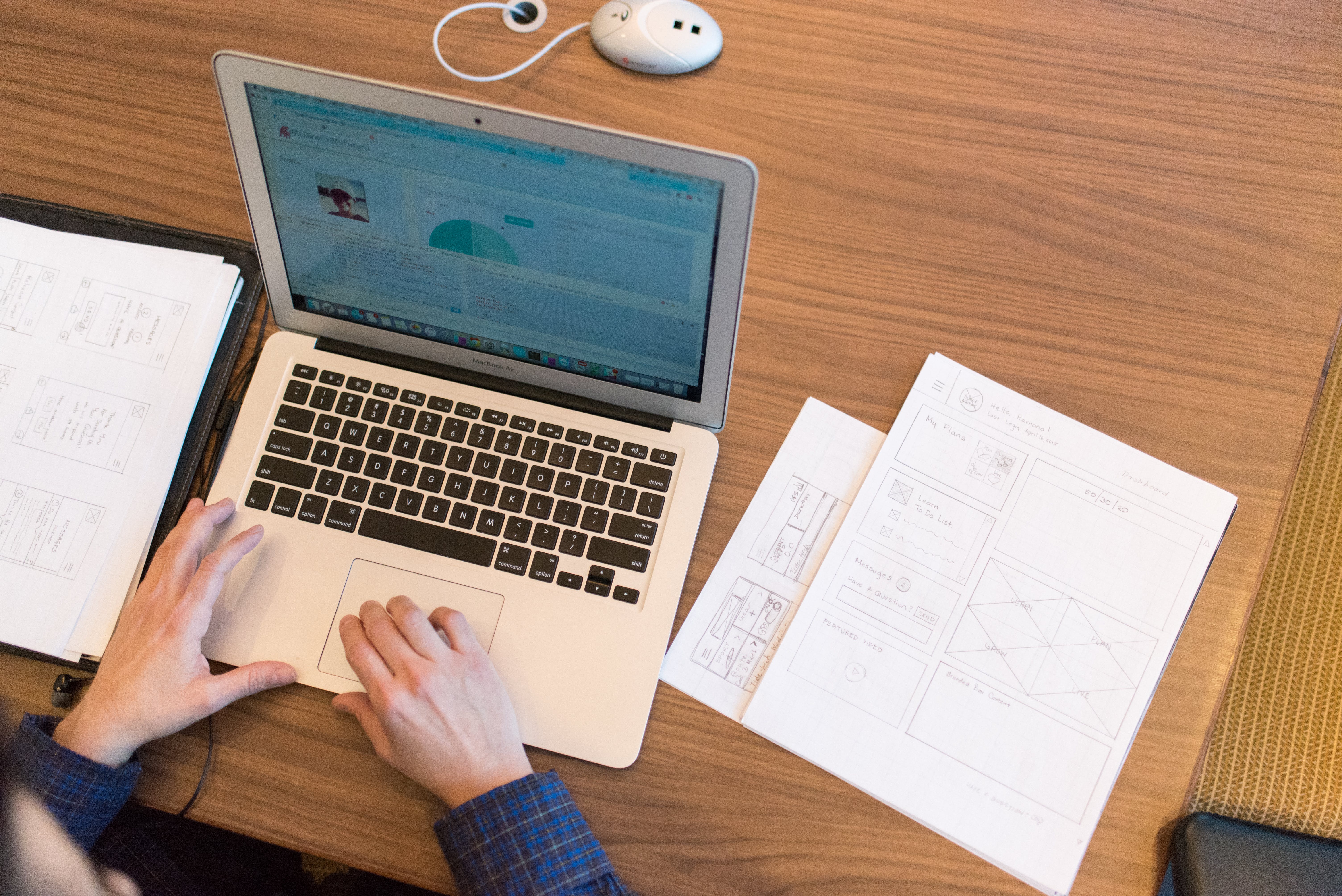 Person in front of macbook looking at their success rate with top cold outreach methods