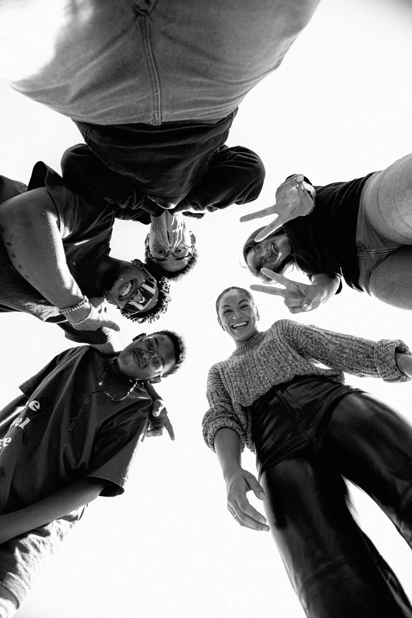 Friends in a circle looking down at the camera