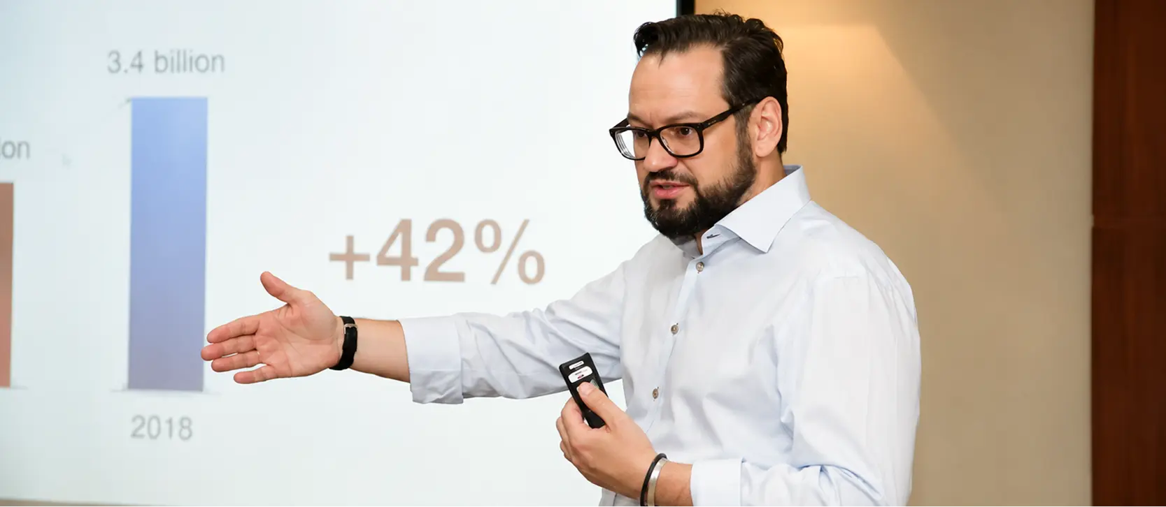 Instructor presenting business growth data on a projected slide during a live session