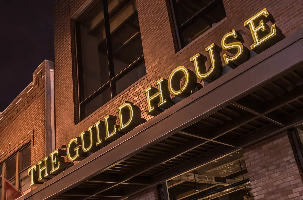 Lit The Guild House sign over the entrance on High Street