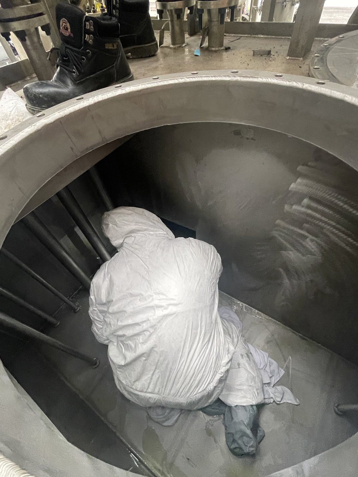 Tank and Reservoir decontamination frontline worker inside tank
