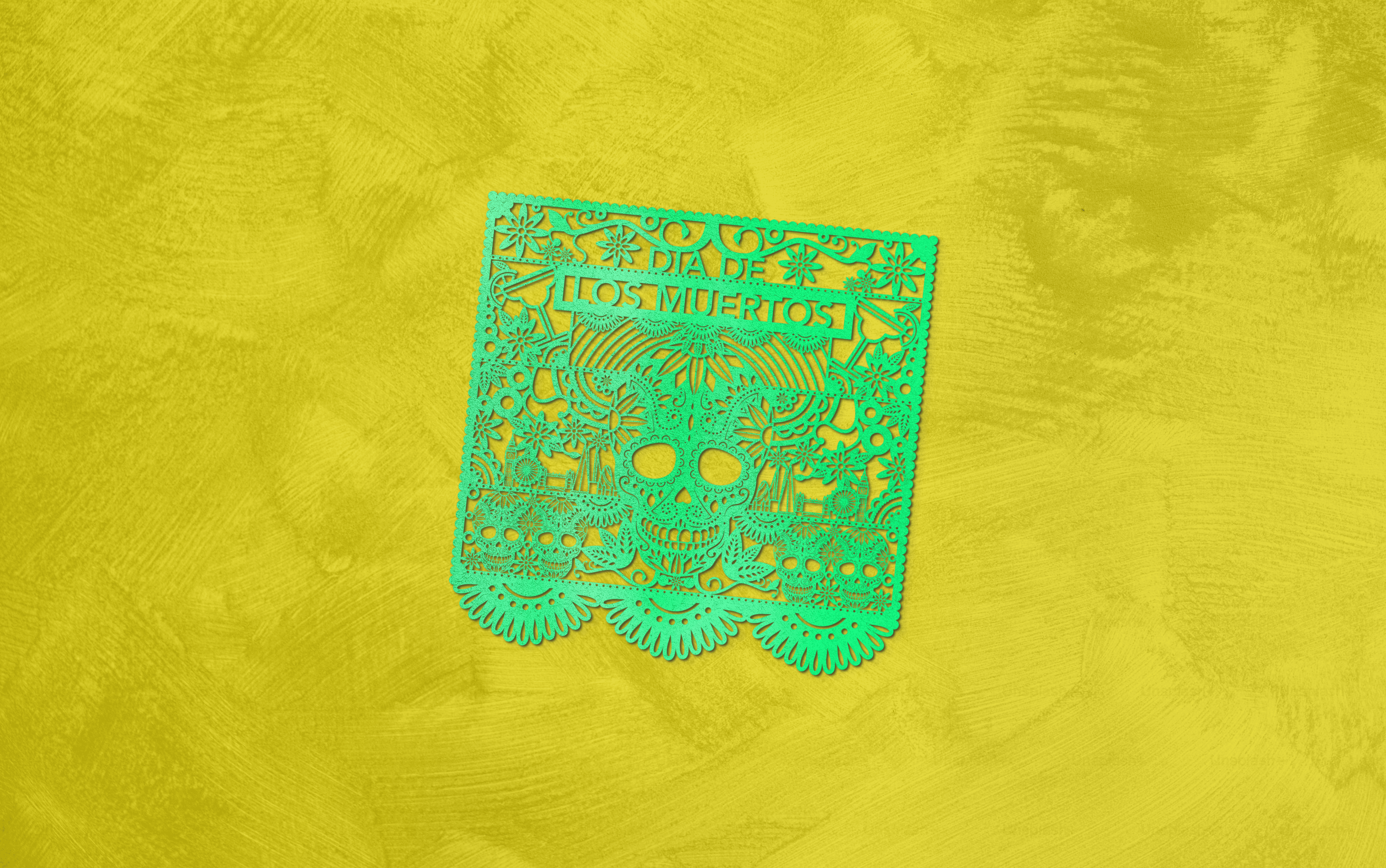 man sitting on a chair in front oof a green curtain