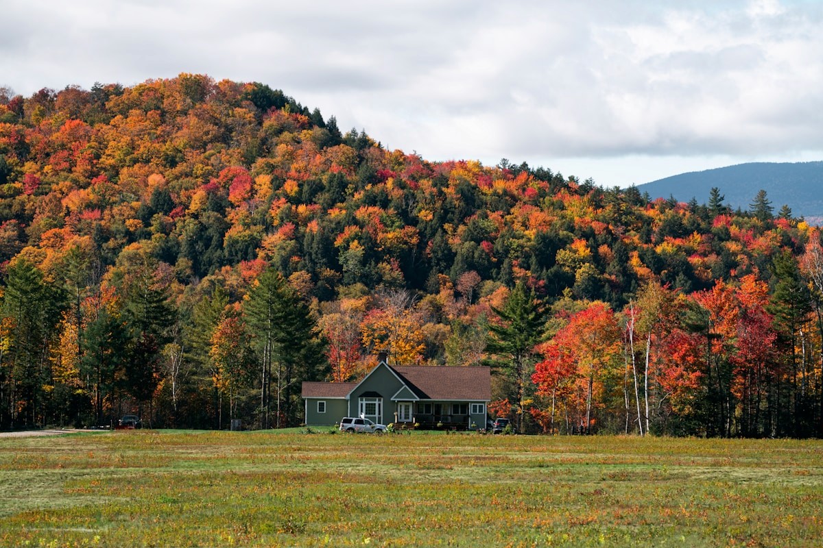 Northeast home surrounded by vibrant autumn foliage