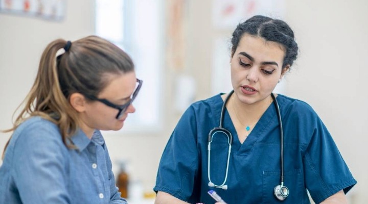 doctor taking medical notes for a patient chart