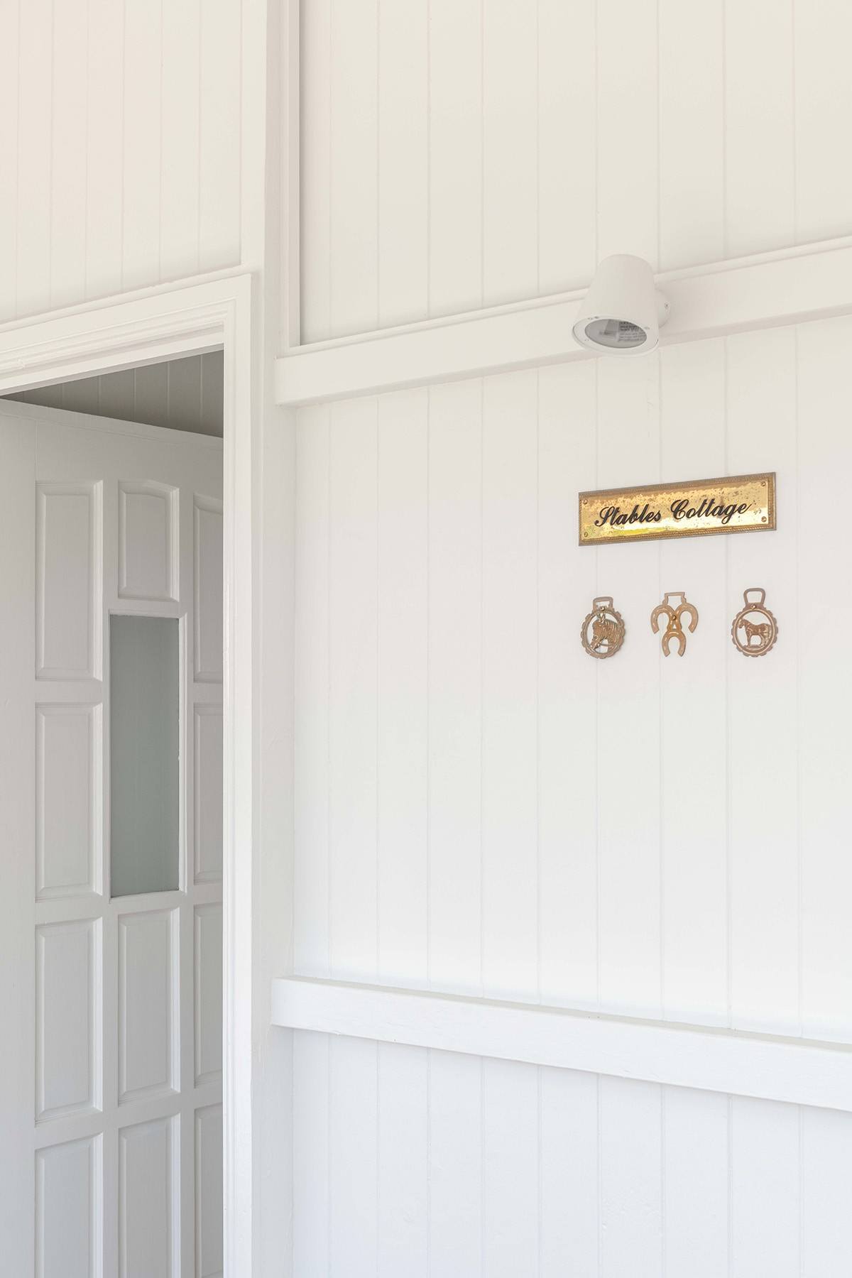 Interior detail at The Stables highlighting painted timber walls, heritage joinery, and a subtle nod to the home’s original character.