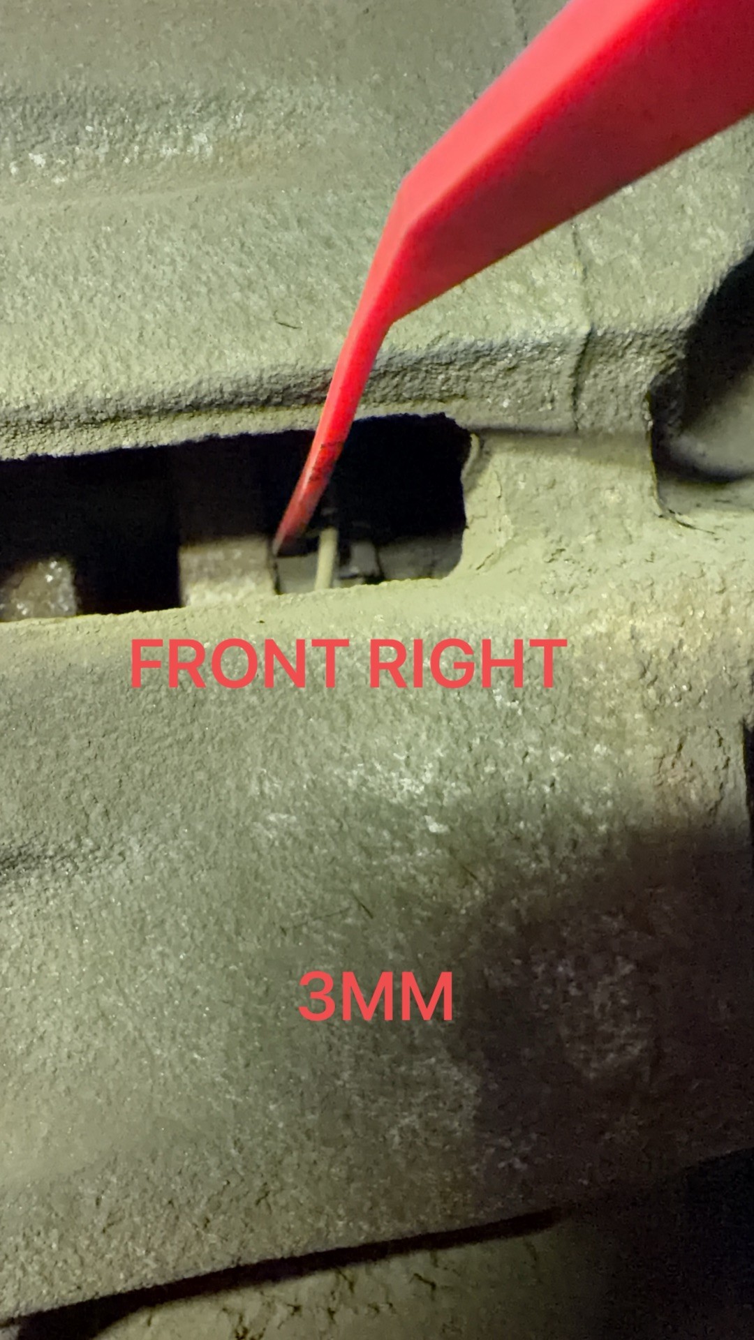Front right brake pad measured at 3 mm through the caliper inspection window