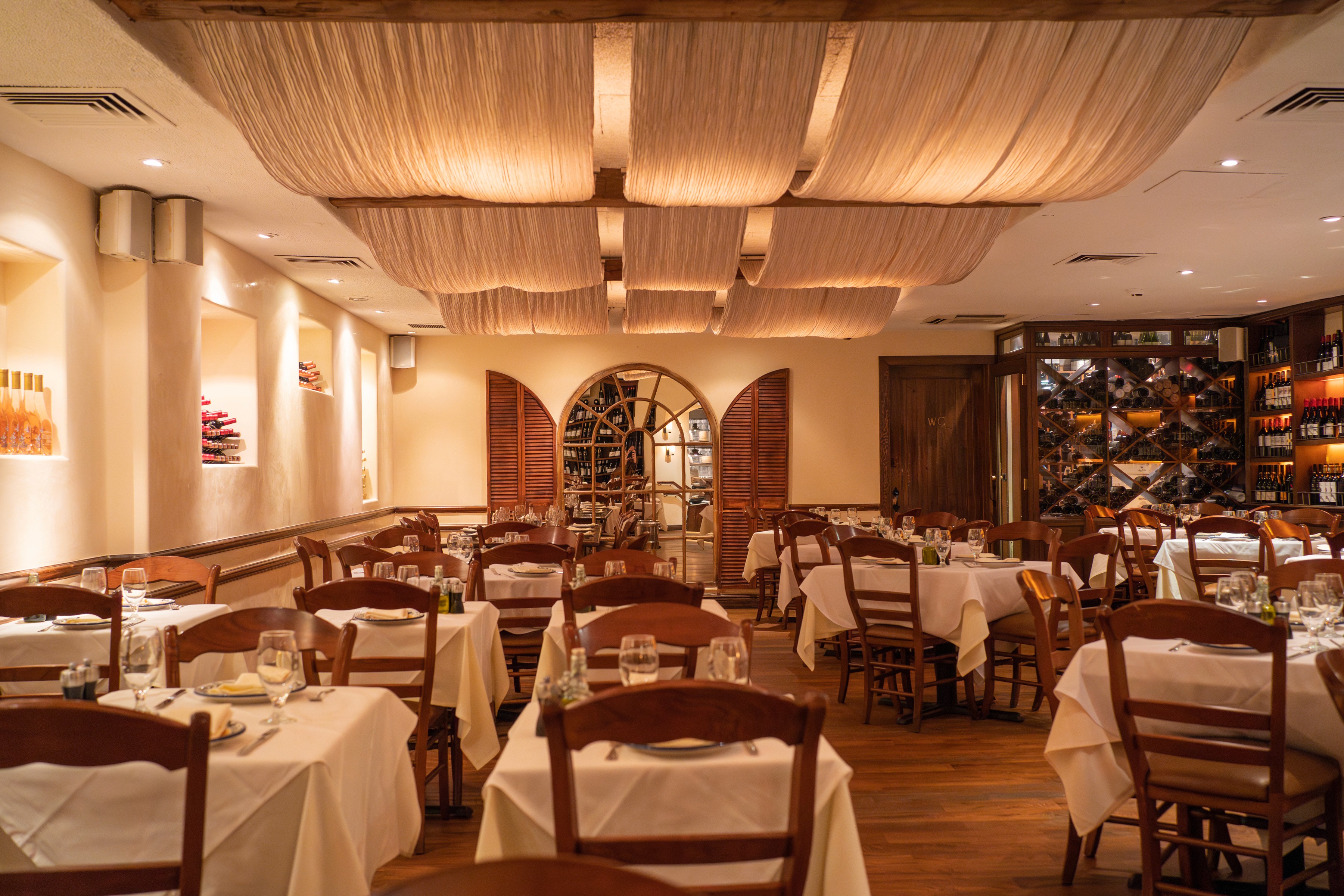 Cozy restaurant interior featuring wooden tables, warm lighting, and a welcoming atmosphere.