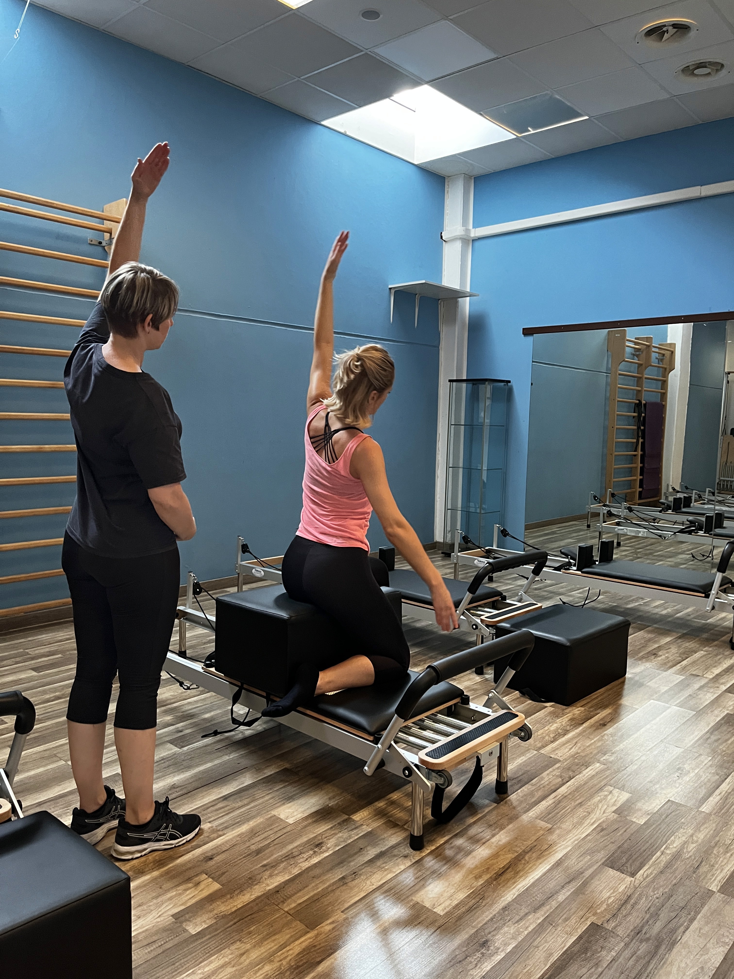 a woman sitting on a rock with a dog