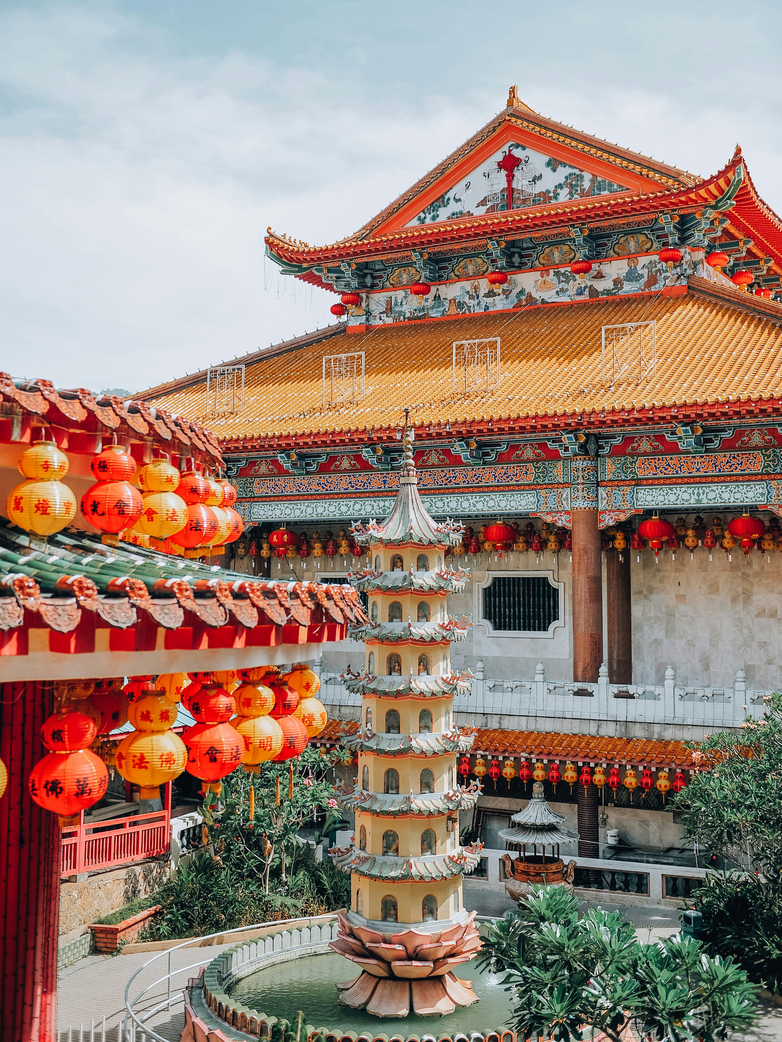 orange and yellow chinese lanterns on white concrete building during daytime