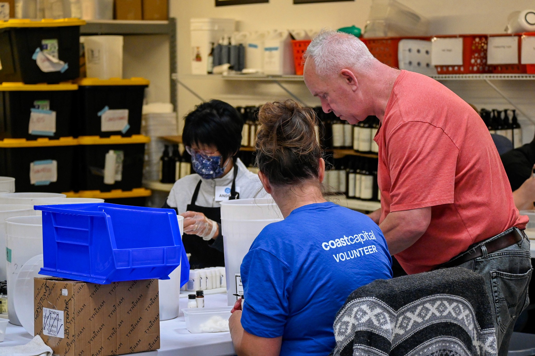 Volunteers and a team member of soap for hope working in th warehouse