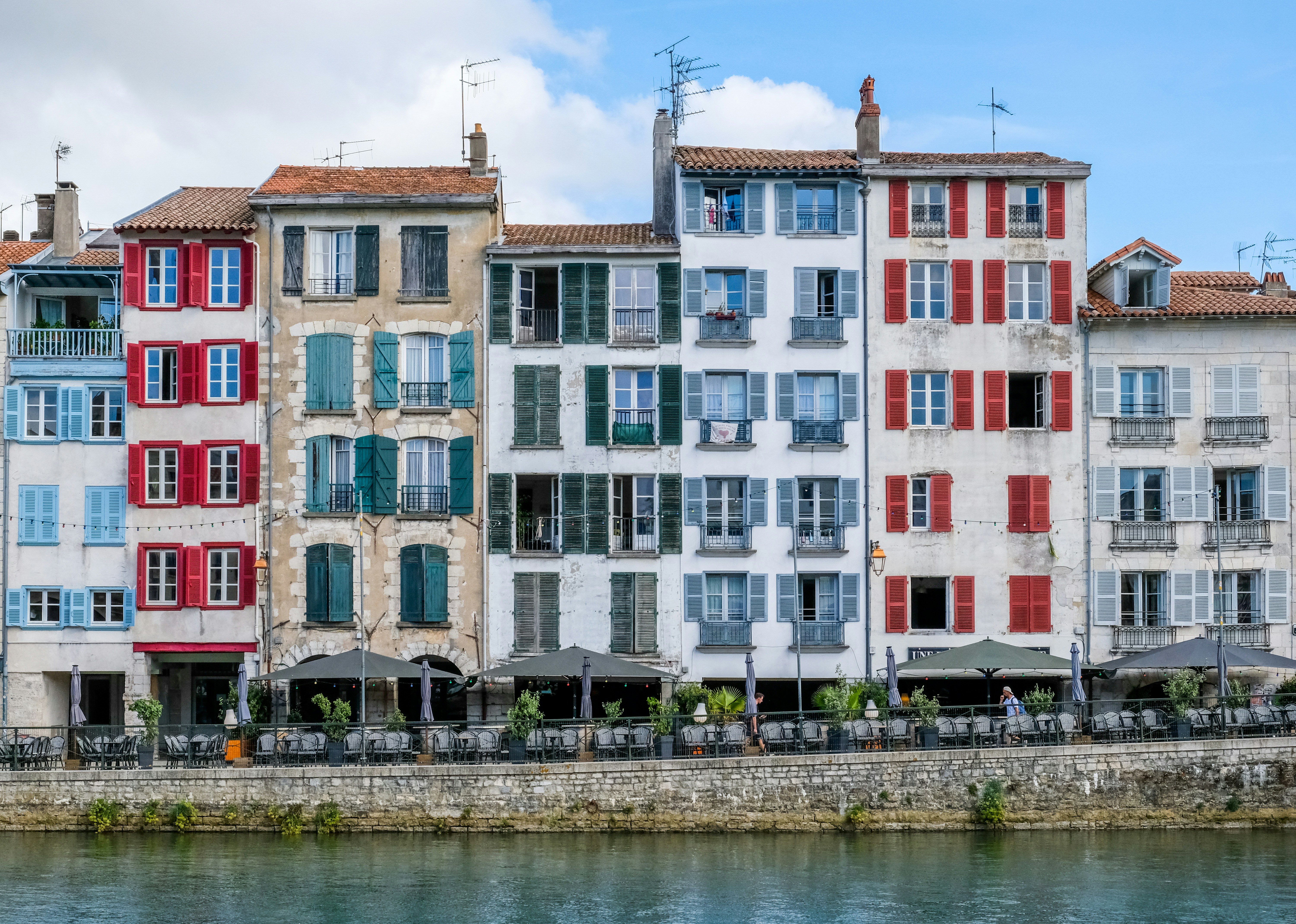 a row of buildings next to a body of water