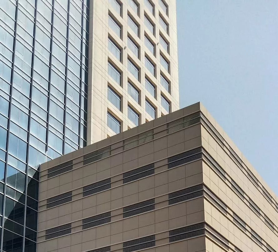 Close-up of Grosvenor Business Tower signage on the modern stone facade of this Dubai commercial landmark.