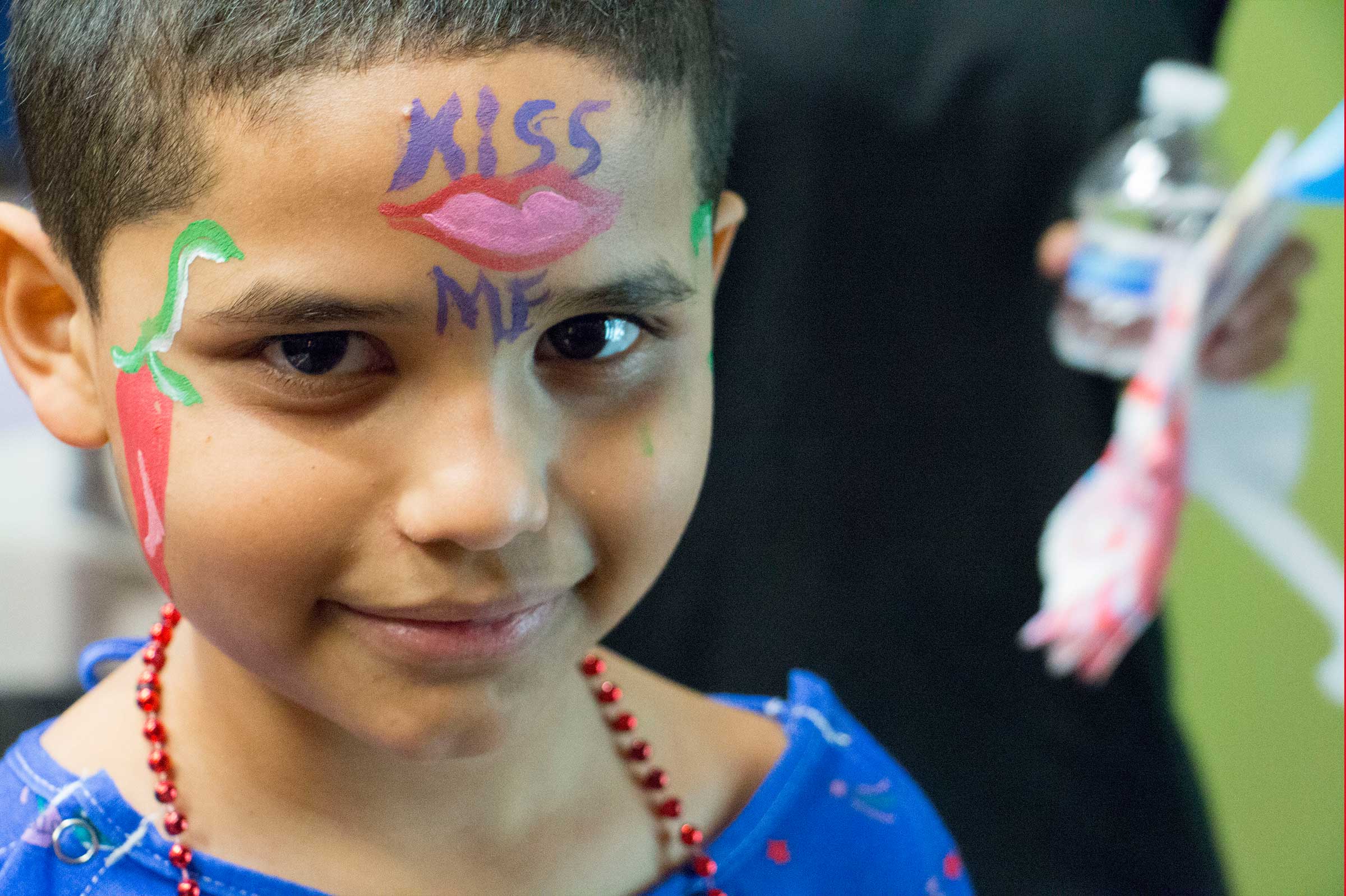 Photo of a sick child and colorful painted face to brighten their day