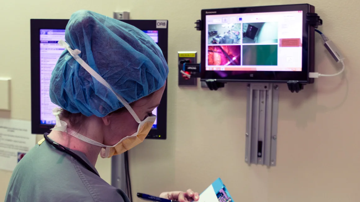 Surgeon in operating room taking notes