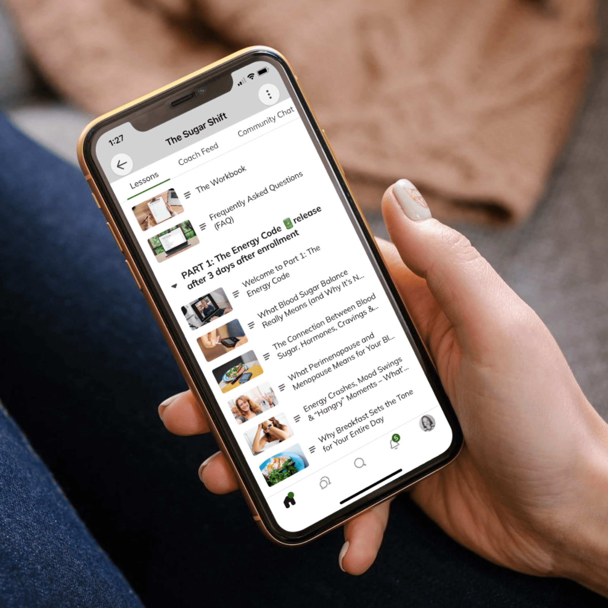 Person holding iPhone displaying RE:YOU program lessons
