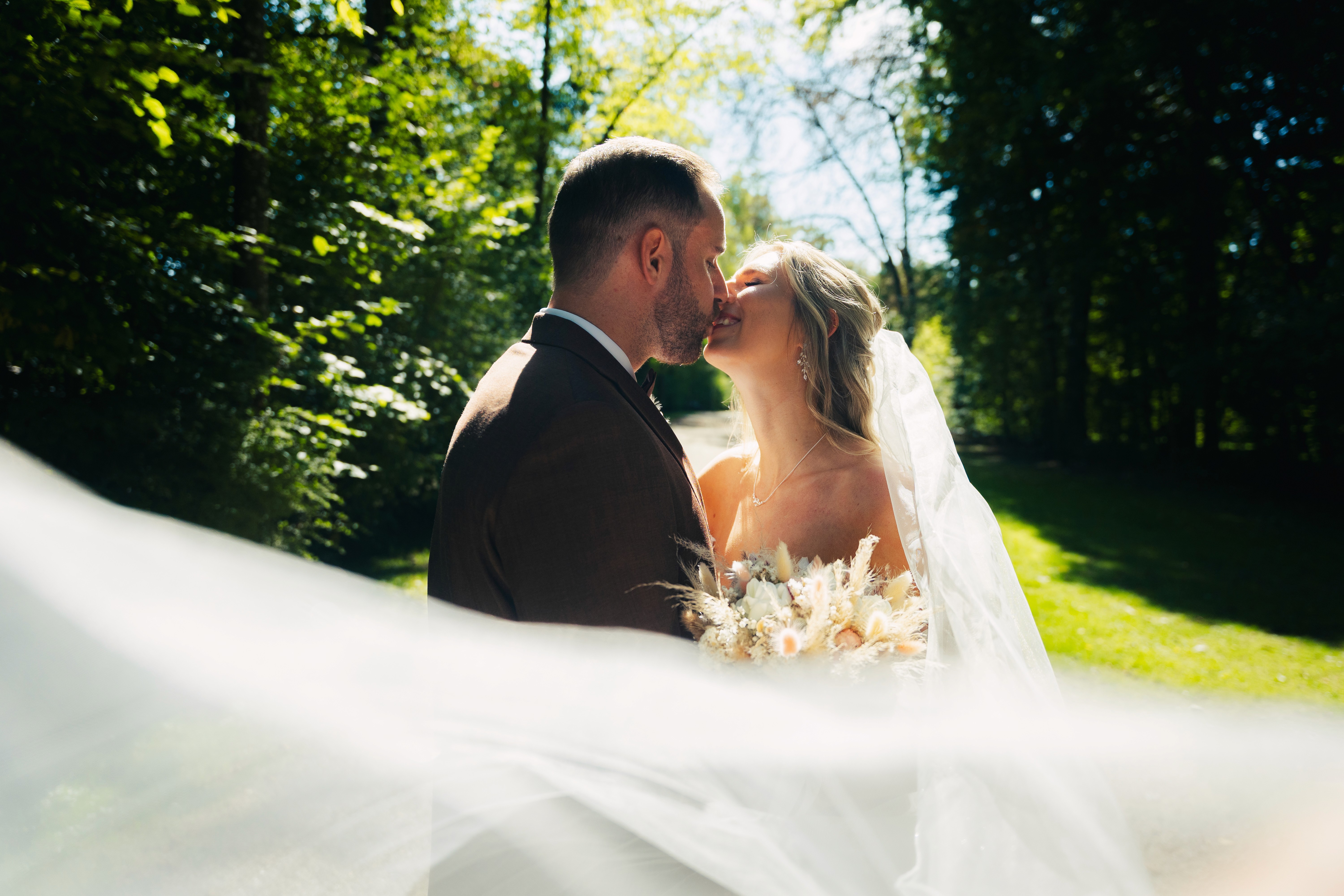 Hikers silhouetted against a clear blue sky at sunset.
