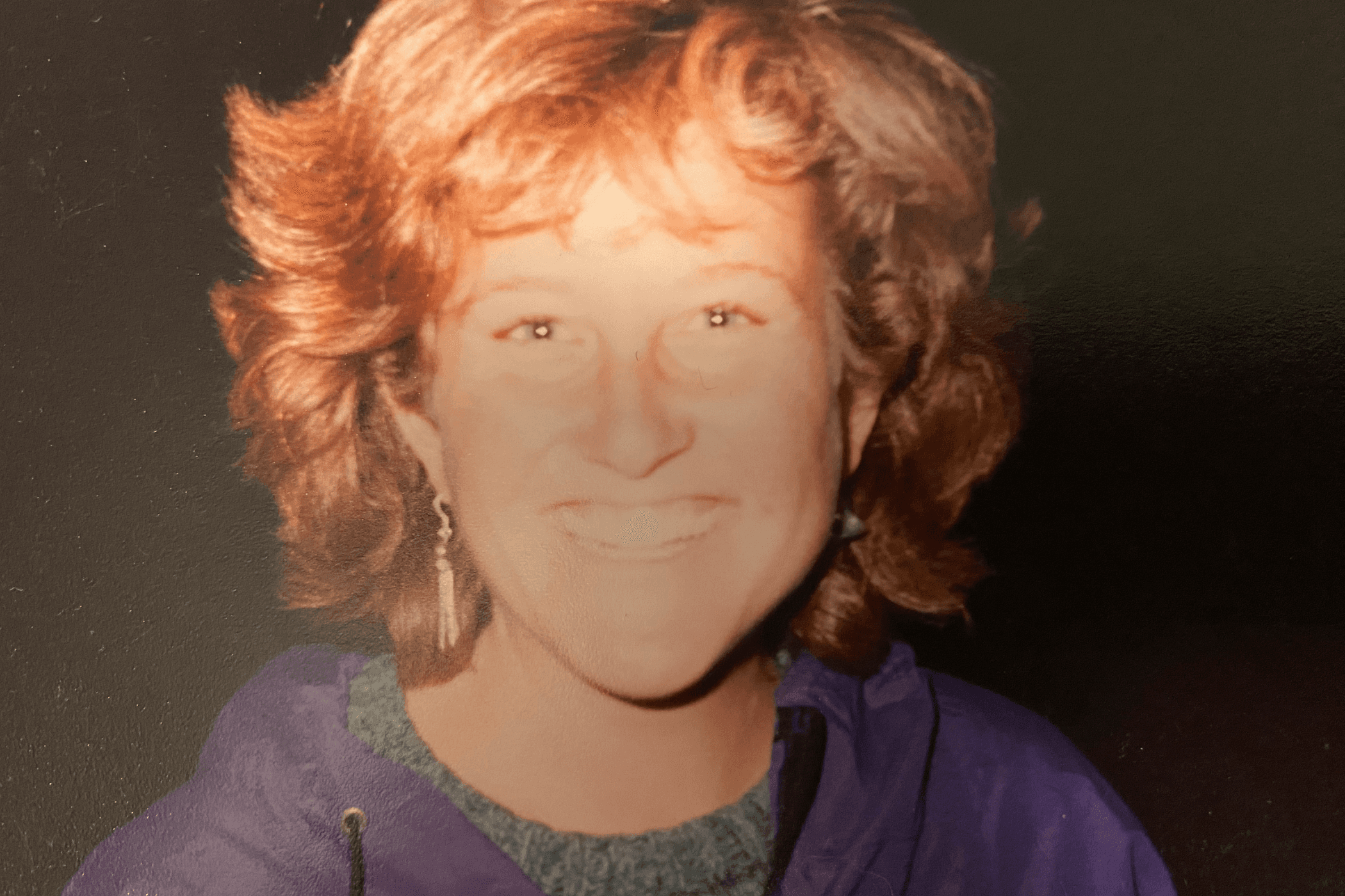 A young woman looks at the camera and smiles
