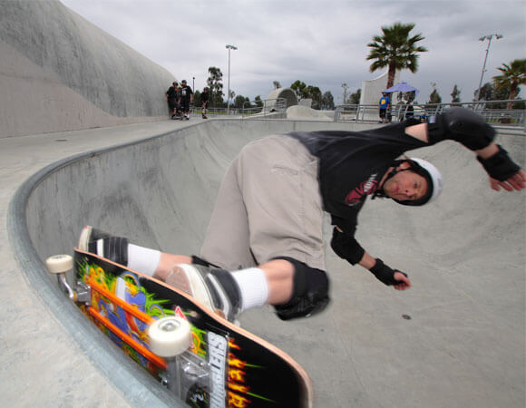 Gary grinding a 50/50 on his skateboard.