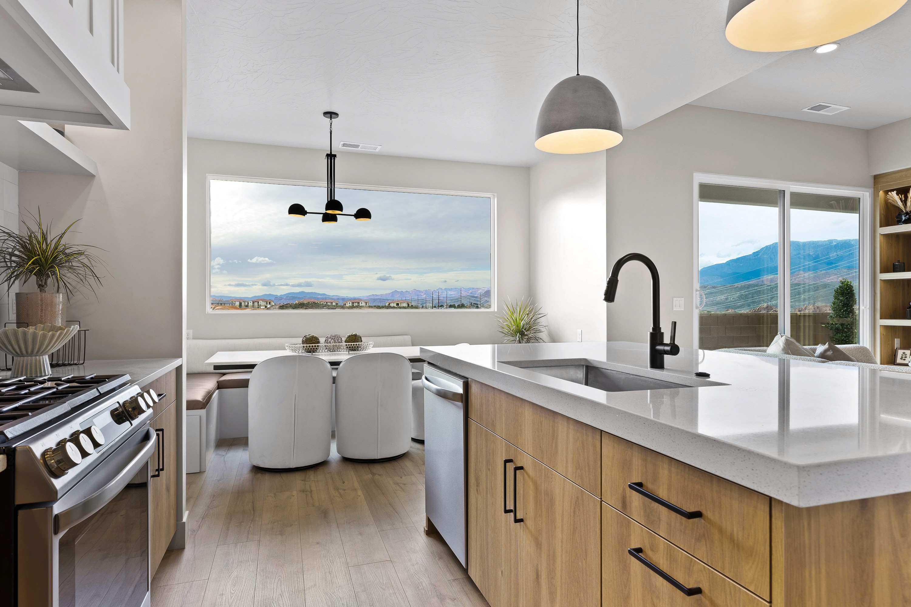 Kitchen view in the BYSO House in Hurricane, Utah looking into dining space, showcasing open layout.
