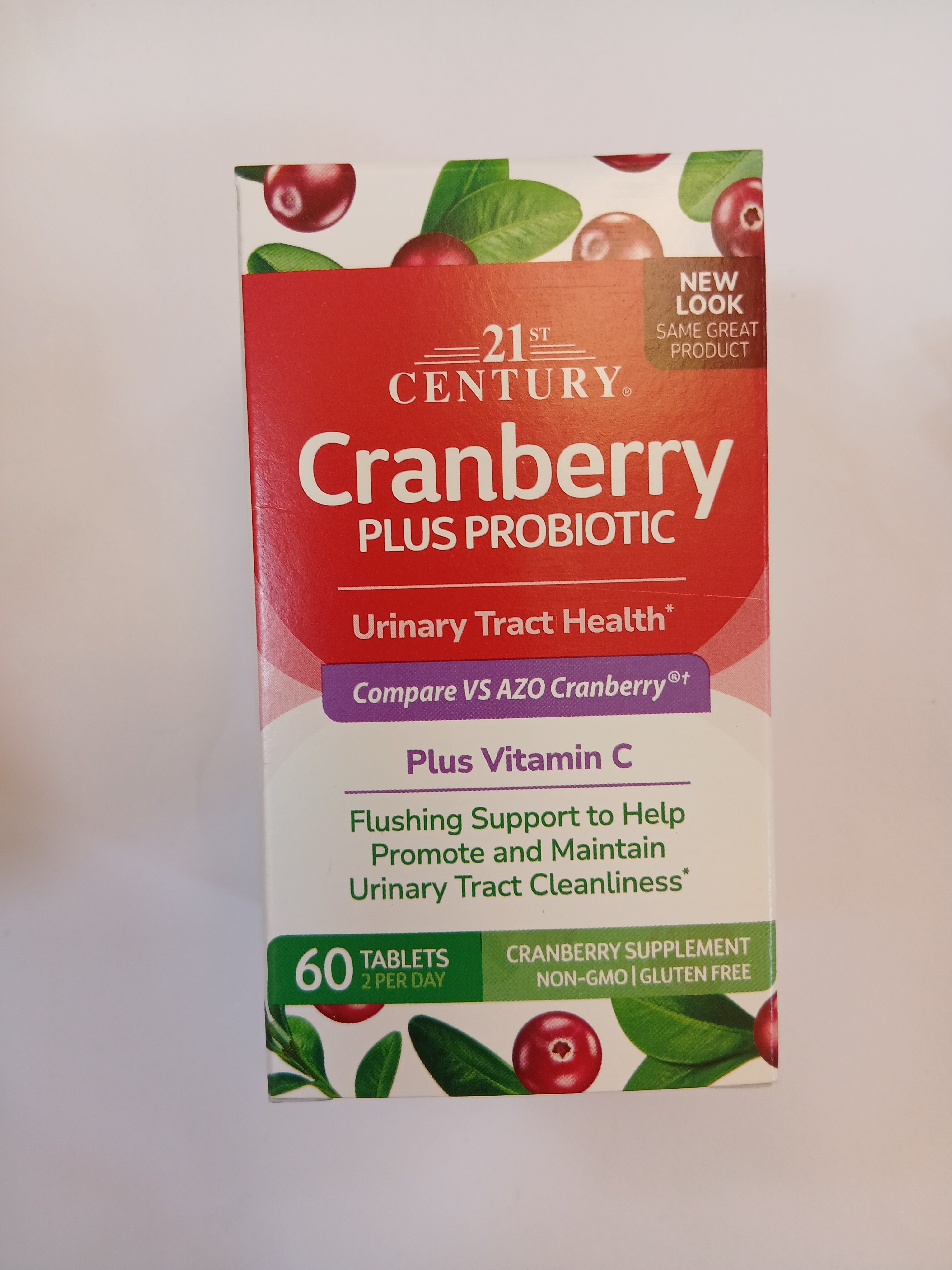 A white cardboard box with red and green graphics displays a 60-tablet blister pack of cranberry and probiotic supplement, featuring images of cranberries and text about urinary tract health benefits.