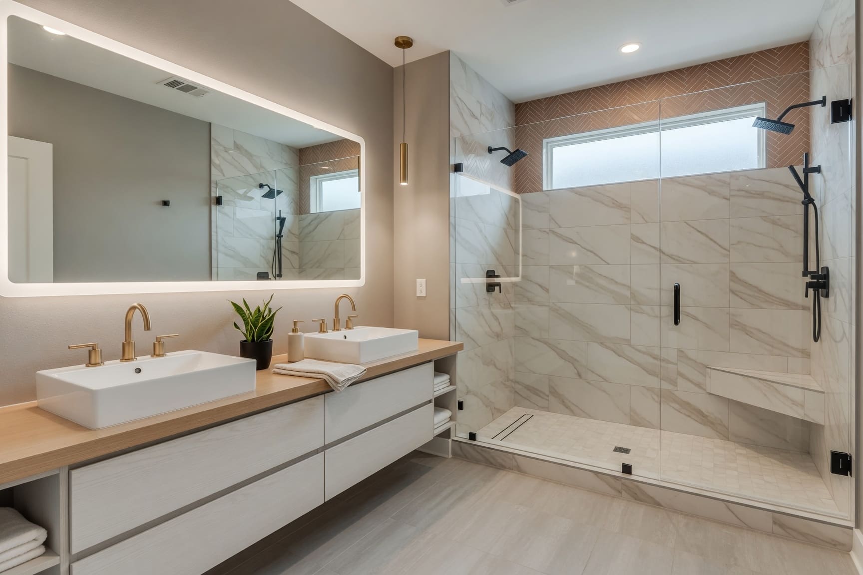 Marble bathroom with walk-in shower and backlit mirror