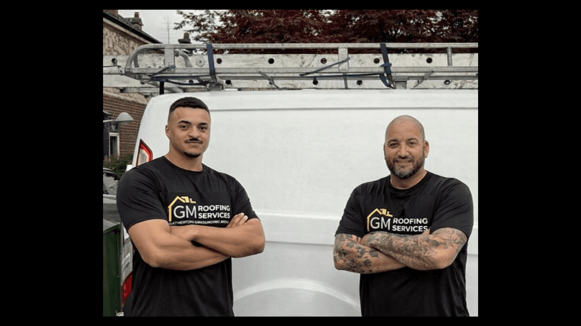 two men working on the roof of a house