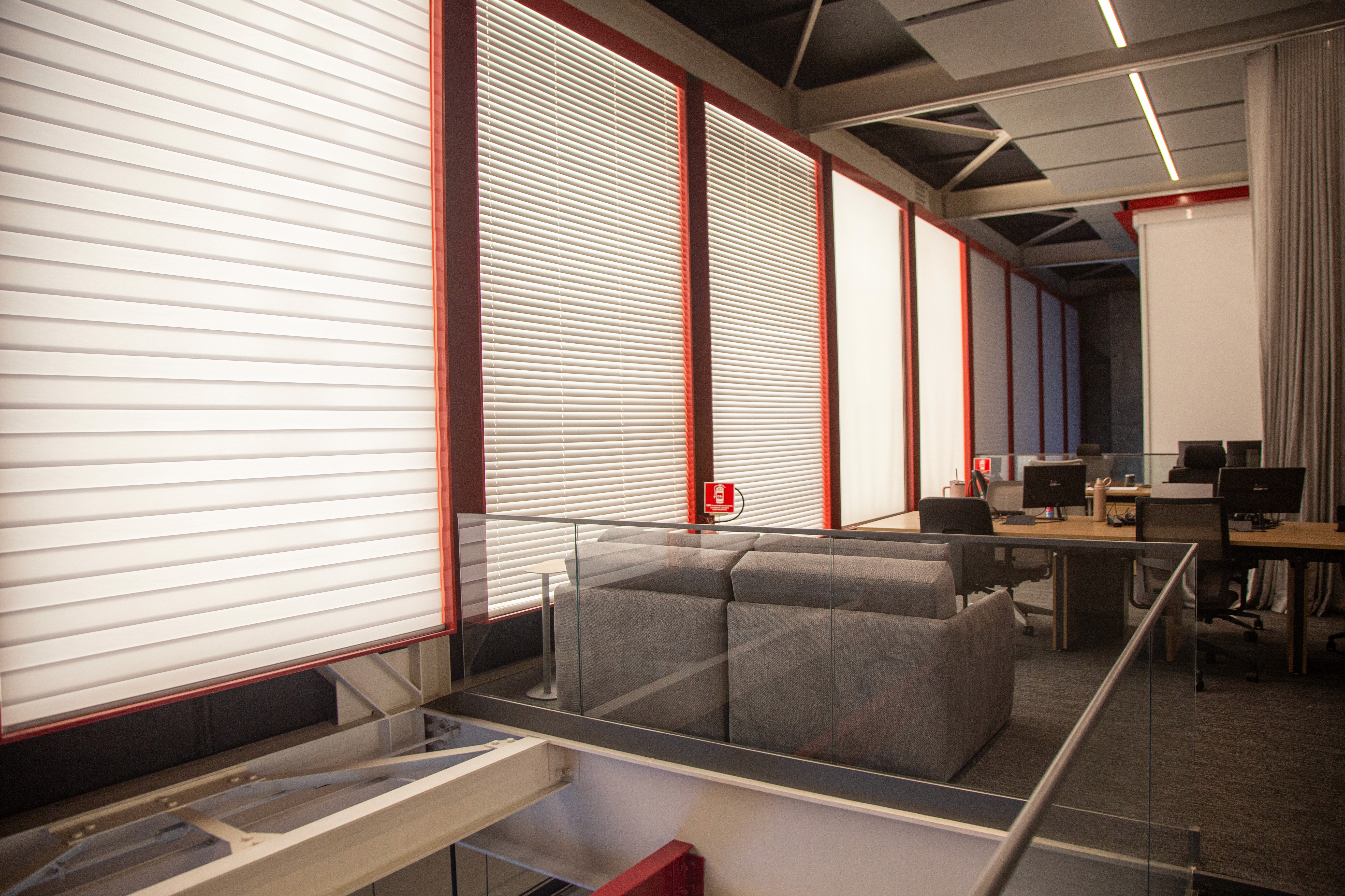 Terracotta workspace with custom wooden desk, warm plaster walls, natural light, and abstract wall art.