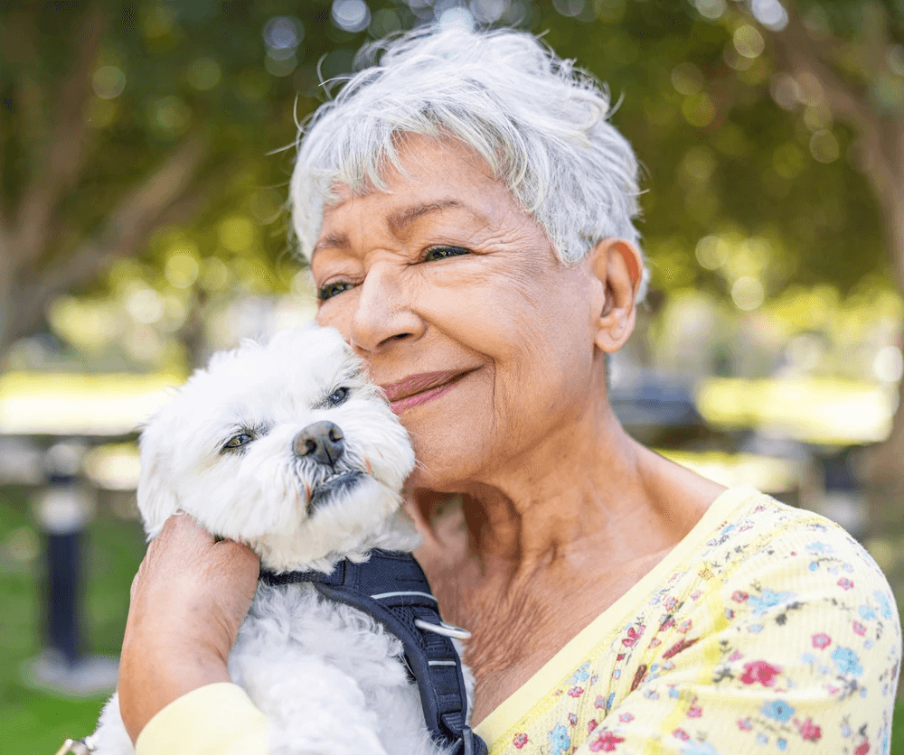 Senior woman and white dog