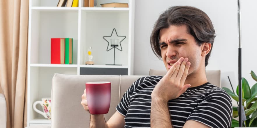 Чоловік тримається за щоку